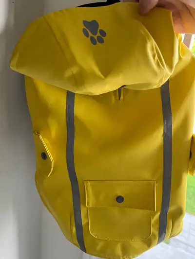 Thick yellow raincoat with grey reflective strip. Item fits a bit bigger than the size. New. Never u...