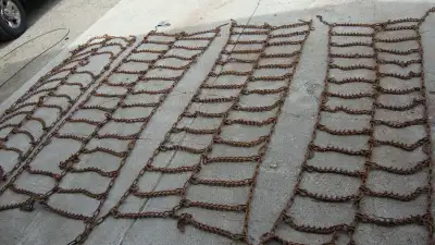 2 sets, 24.5 tire chains, 1 set heavily used and 1 set almost new. Rusty but good shape.