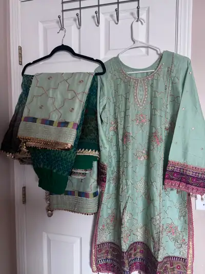 This is a beautiful, new salwar kameez, perfect for festive occasions. It features intricate embroid...