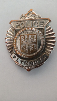 Plymouth Massachusetts Police Badge center features Seal of city