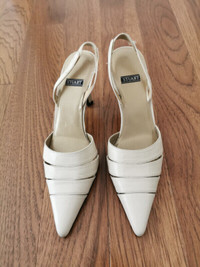 A pair of used light beige Stuart size 4.5 lady shoe