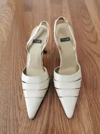 A pair of used light beige Stuart size 4.5 lady shoe