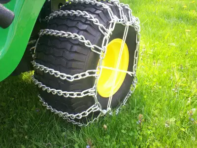 Brand new lawntractor tire chains installed on tractor for showing size but never been used.