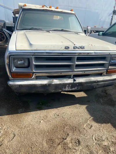 White, 318 V8 motor, runs. Gravel truck. Located in Regina.