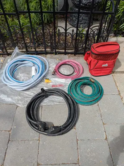 25ft RV power cord, 2- 25ft potable water hoses, jiggler siphon hose, water nozzle, insulated snack...