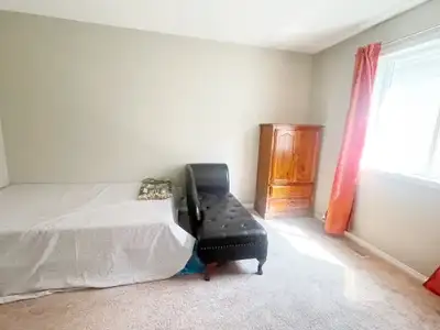 This bright and comfortable guest bedroom is available now in a quiet home in Airdrie SW, offering a...