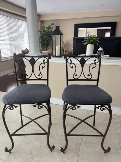 Set of 2 counter-height wrought iron bar stools in excellent condition. Sturdy metal frame with eleg...