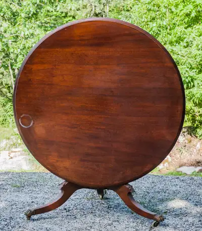 FOLDING ROUND KITCHEN TABLE. 48 INCH DIAMETER, 29 INCHES HIGH. METAL CLAW FEET WITH WHEELS. STURDY U...