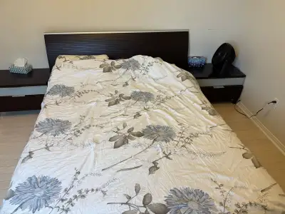 A comfortable Queen size bed. Includes a headboard, bed frame and bedding. The bed has two nightstan...