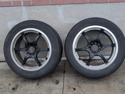 These used wheels feature a sleek black finish with a polished lip, perfect for enhancing your vehic...
