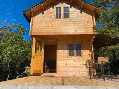“Kiltearn on the Peak” is a stunning but cozy tiny house on Buck Lake in South Frontenac, about 30 m...
