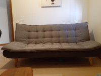 Upholstered futon with top mattress pad