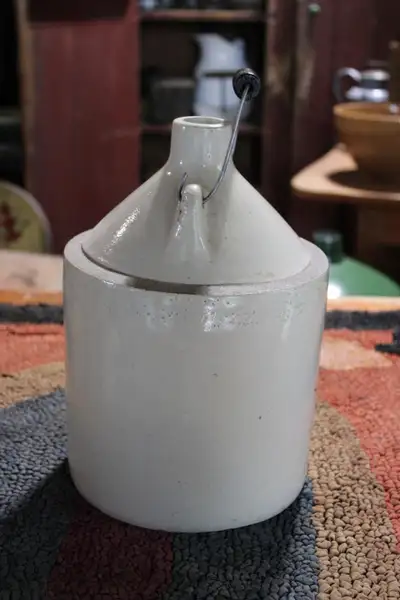 Hi. I have a vintage stoneware jug/crock with wire handle for sale. The jug shows light wear and mar...