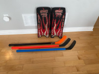 Hockey sticks, goalie pads