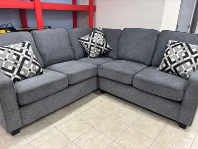 Upgrade your living space with this stylish and comfortable grey sectional sofa, perfect for relaxin...