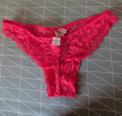 Add a touch of lace to your collection with these La Senza hot pink lace thong panties in size XS. T...