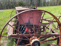 Farm equipment - antique seeder with metal wheels