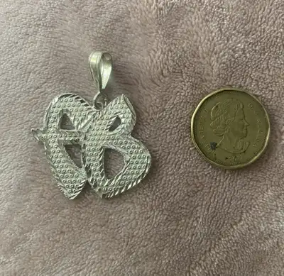 Check out this vintage sterling silver FUBU pendant! This piece is definitely a statement maker. It'...