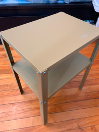 Small beige metal shelf unit or nightstand