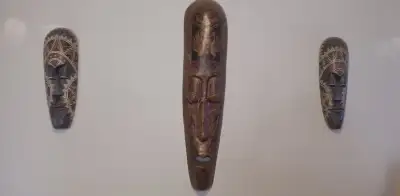 Indonesian masks, originally purchase from Ten Thousand Villages, 2014. Slight damage to the largest...