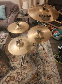 Assorted Sabian AA/AAX cymbals for drums.