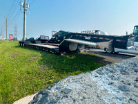 New line up of equipment trailers and Autocar dump trucks.