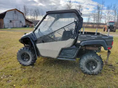 This side by side in fully inclosed . It has a cab heater , circulating block heater , led lights. I...