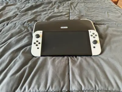 I'm selling my Nintendo Switch OLED, a versatile gaming console that delivers stunning visuals and i...