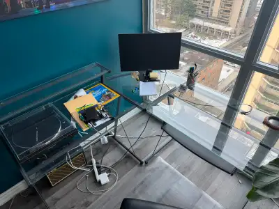Selling an L-shape glass panel, metal frame desk. Fits great into a corner of a room. One side has a...