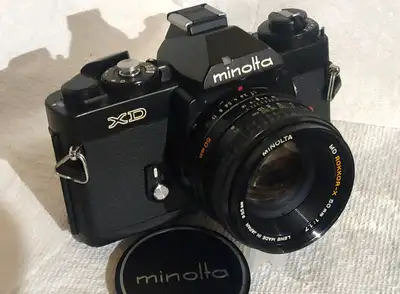 This Black Minolta XD is loaded with features including aperture priority. It's a stunning example o...