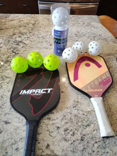 2 pickleball paddles and 9 balls for sale. The paddles are in excellent condition, hardly used. 3 in...