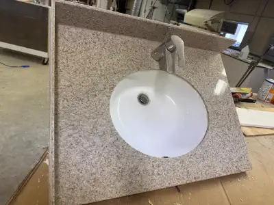 Vanity top is 31 wide by 22-1/2 deep everything in good condition It has 1/2 layer granite on top wi...