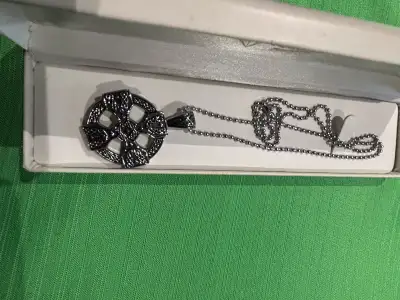 This Celtic cross necklace is a unique and eye-catching piece, featuring a detailed cross pendant on...