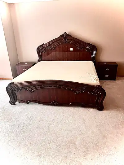 Transform your bedroom with this exquisite, ornate king-size bed frame, crafted with rich dark wood...