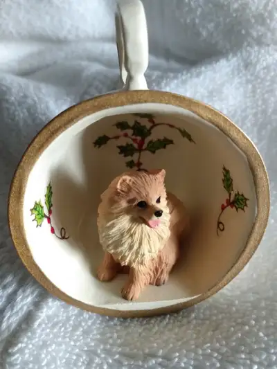 New beautiful ornament of a Pomeranian sitting in a tea cup. Very cute. Makes a great gift for Pomer...