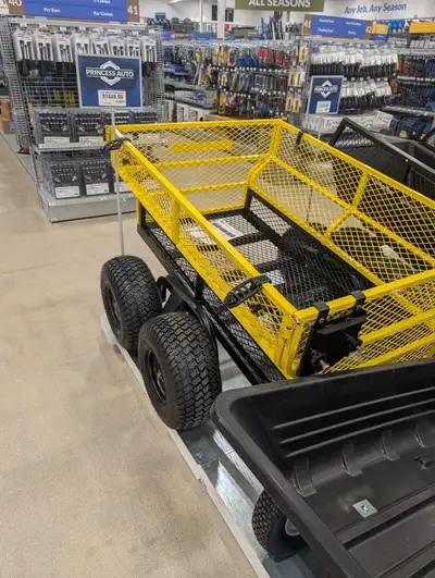 This heavy-duty utility garden trailer features a durable steel mesh design, perfect for hauling lan...