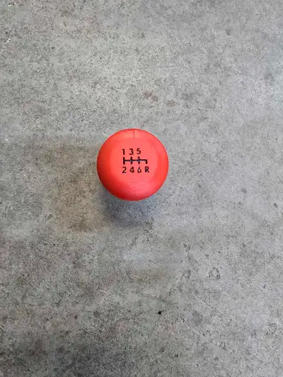 Elevate your driving experience with this vibrant red 3D printed STi shift knob, designed with a cla...