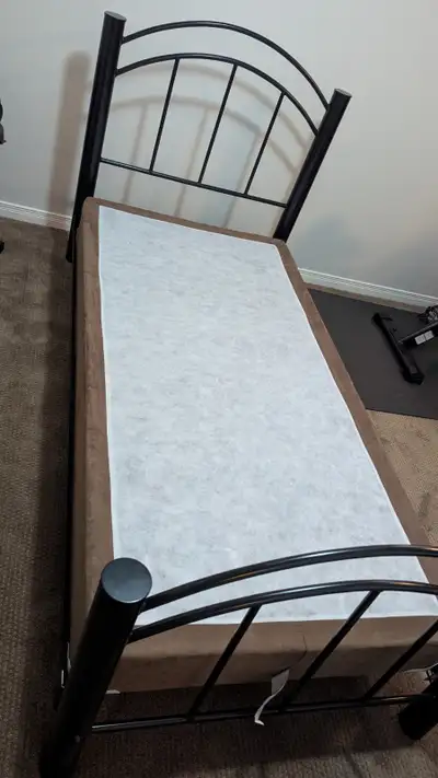 Selling a sturdy twin-size bed frame complete with a box spring mattress. Includes head and foot met...
