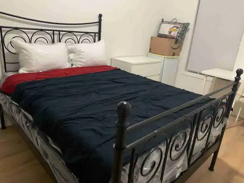 This is a cozy furnished bedroom in a 3-B/rm apartment available for rent, located on Simcoe Street...