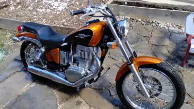Copper and black colour. Side saddle bag mounts included. Stored indoors. New battery purchased 2024...