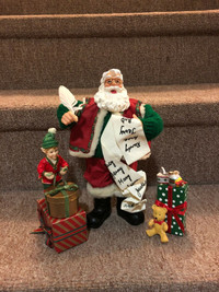 Santa, elves and presents statue