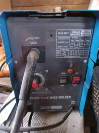 Small wire feed welder with helmet