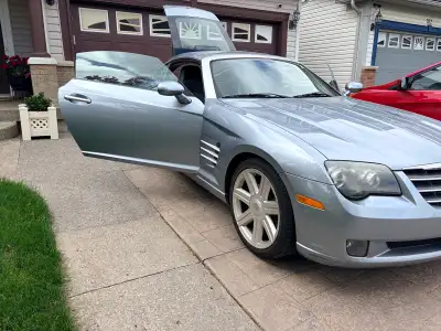 Are you looking for a stylish, fun-to-drive sports car with classic appeal? This 2004 Chrysler Cross...
