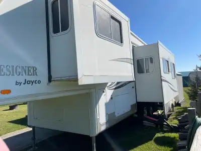 Parked on a large lot at Spruce Heaven golf course and RV park. Two slides dinette/pullout couch, an...
