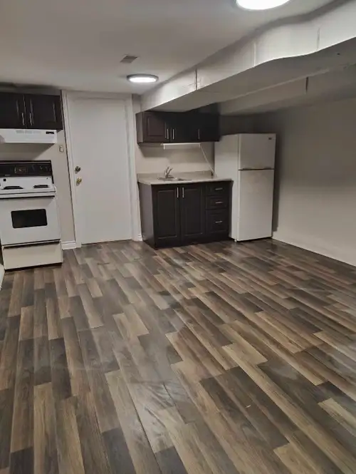 This bright and tidy basement apartment is perfectly situated near Woodbine and Queen, offering a fu...