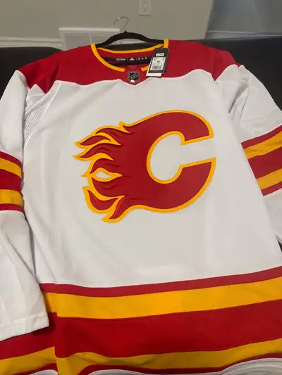 Adidas NHL Calgary Flames Jersey. It still has the tag on. Authentic NHL Jersey Collection. Size is...