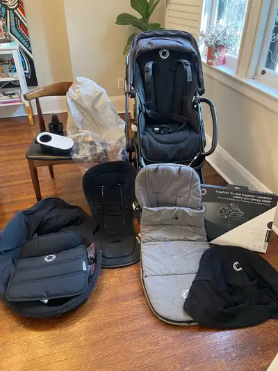 Black Bugaboo Stroller with tons of accessories , View more
