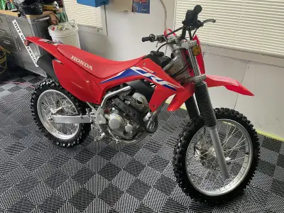 Absolutely mint, real nice dirt bike with not a mark on it! Battery tender included