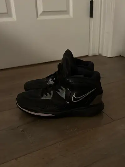 Nike Kyrie basketball shoes in youth size 5.5Y. They are black with purple accents. Available to mee...