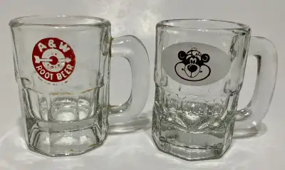 Available if posted. Set of two baby glass mugs. Arrow and Rootbear. Good condition. Selling as a se...